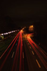 High angle view of light trails on highway at night