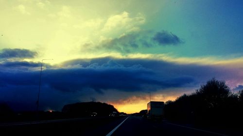 Road passing through dramatic sky