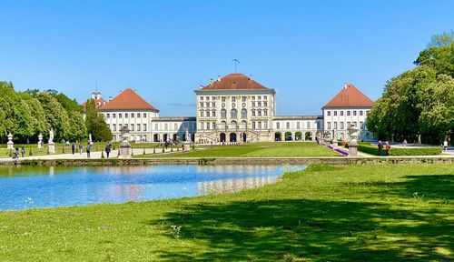 View of swimming pool by lake against buildings