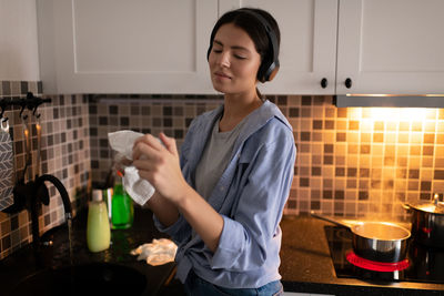 Mid adult man holding food at home