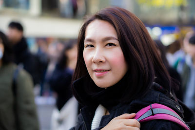 Portrait of smiling young woman outdoors