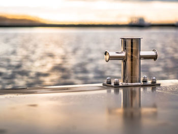 Close-up of railing against sea