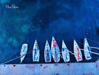 High angle view of sailboats moored on wall