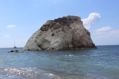 Scenic view of rocks in sea against sky