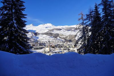 Scenic view of snowcapped mountains against blue sky
