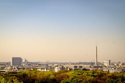Panoramic view of buildings in city against clear sky