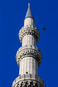 Low angle view of historic building against blue sky