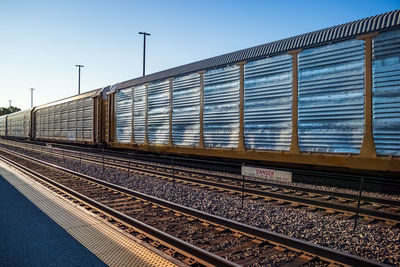 Train at railroad station against clear sky