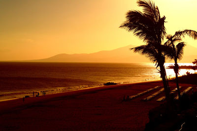 Scenic view of sea and beach against sky during sunset