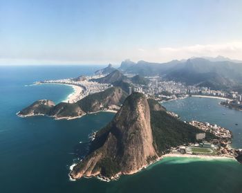 Aerial view of sea and mountains against sky