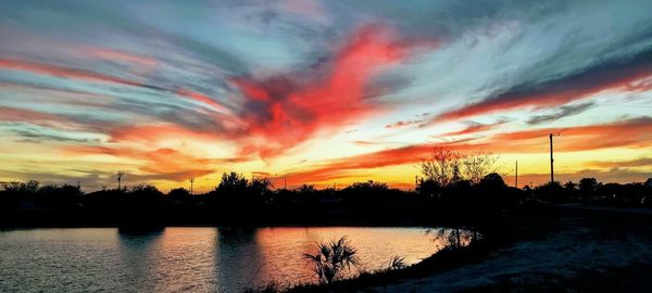 Scenic view of lake against romantic sky at sunset