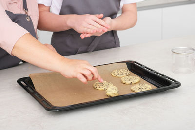 Midsection of woman preparing food on table