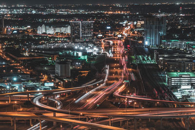 High angle view of city lit up at night