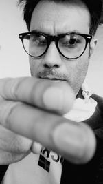 Close-up portrait of man wearing eyeglasses