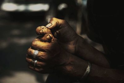 Close-up of cropped hand holding plant