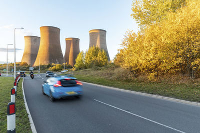 Uk, england, rugeley, traffic in front of cooling towers of coal-fired power station