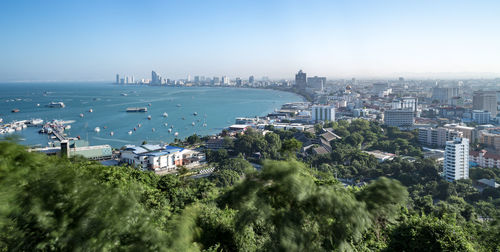 High angle view of buildings by sea against sky