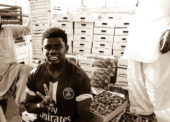 Portrait of young man standing in store