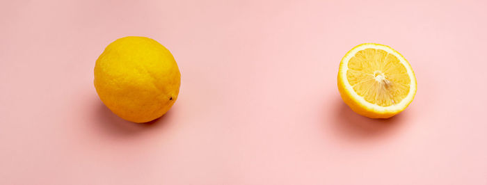 Close-up of lemon slice against orange background