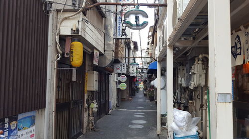 Empty alley amidst buildings in city