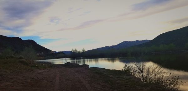 Scenic view of lake and mountains against sky