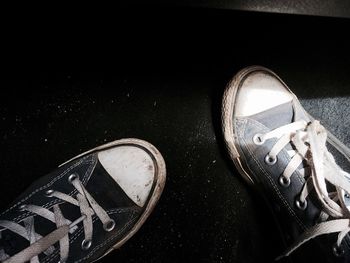 Low section of shoes on tiled floor