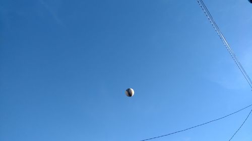 Low angle view of moon against blue sky