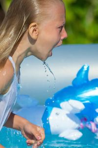 Close-up of baby hand in swimming pool