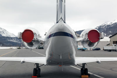 Airplane on runway against sky