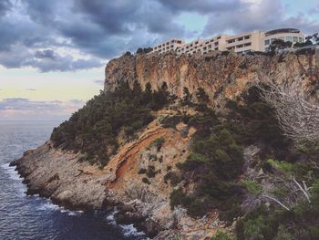 Rock formations by sea against sky