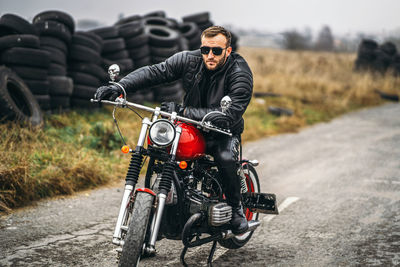 Man riding motorcycle on road