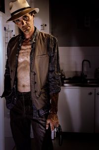 Portrait of man standing at home