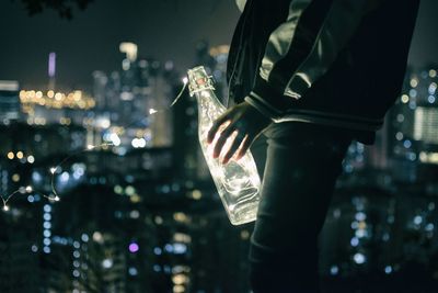 Close-up of hand holding illuminated at night