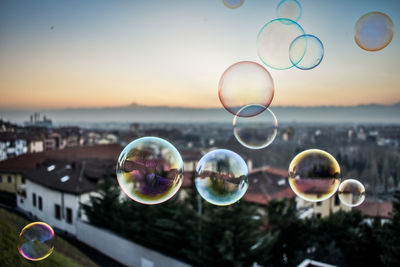 Close-up of bubbles against sky at sunset