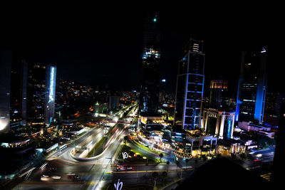 High angle view of illuminated buildings in city at night