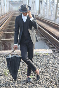 Full length of man walking on railroad track