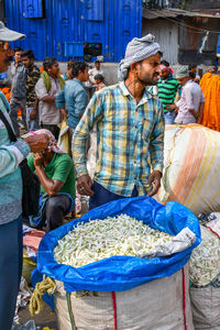 Group of people working at market stall