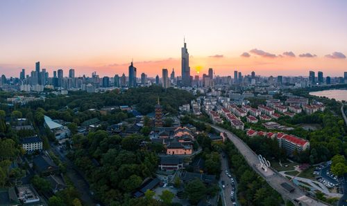 View of buildings in city against sky during sunset