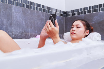 Portrait of woman lying on bed