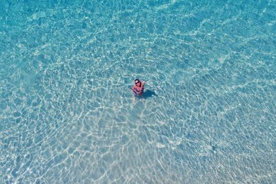 High angle view of woman swimming in pool