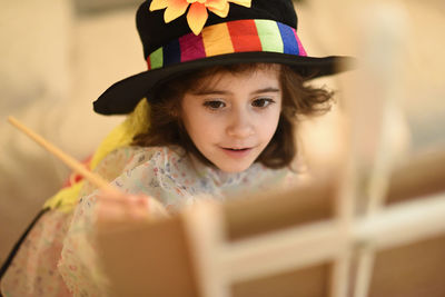 Close-up of girl painting on canvas