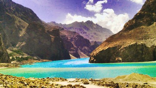 Scenic view of lake by mountains against sky