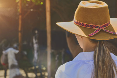 Rear view of woman wearing hat at event