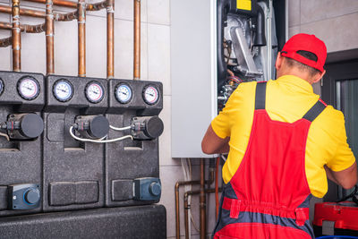 Rear view of man working in factory