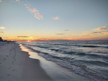 Scenic view of beach against sky during sunset