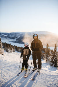 Father and child skiing together
