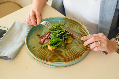 High angle view of woman preparing food on table