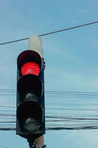 Low angle view of road sign against sky