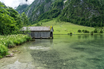 Built structure in lake against mountain in forest