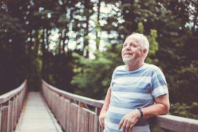 Man standing on footbridge